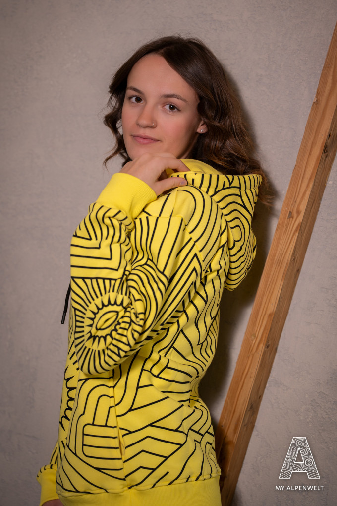 Gelber Hoodie mit schwarzen Alpenwelt Muster am ganzen Pullover