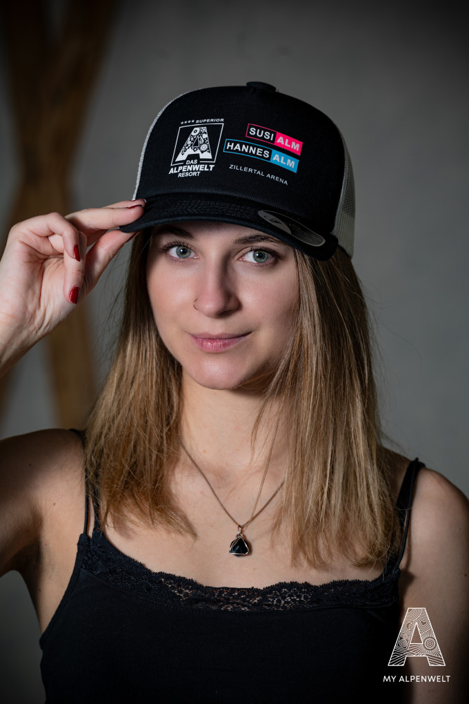 Black Alpenwelt cap with Alpenwelt, Susi Alm, Hannes Alm, and Zillertal Arena logos
