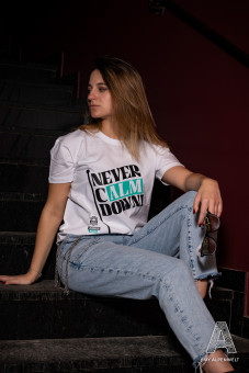 White T-shirt with the words “never calm down” and the Hannes Alm logo on the front