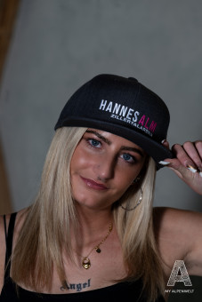 Black cap with white and pink Hannes Alm logo
