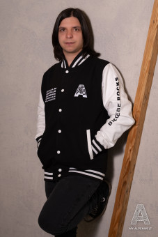 Black and white college jacket: Alpenwelt logo on the front left, Bergliebe.Rocks lettering on the left sleeve