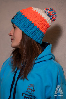blue-orange-white wool hat with white pom-pom & Alpenwelt, Susi Alm, and Hannes Alm logo patch